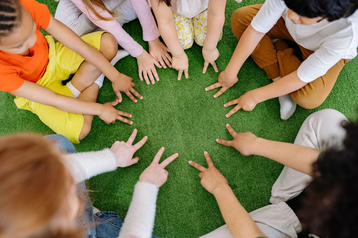 Large group playing a circle party game - Best clean party games